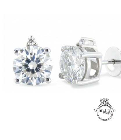 A pair of elegant diamond earrings with a large, brilliant-cut diamond set in a silver-toned metal frame.