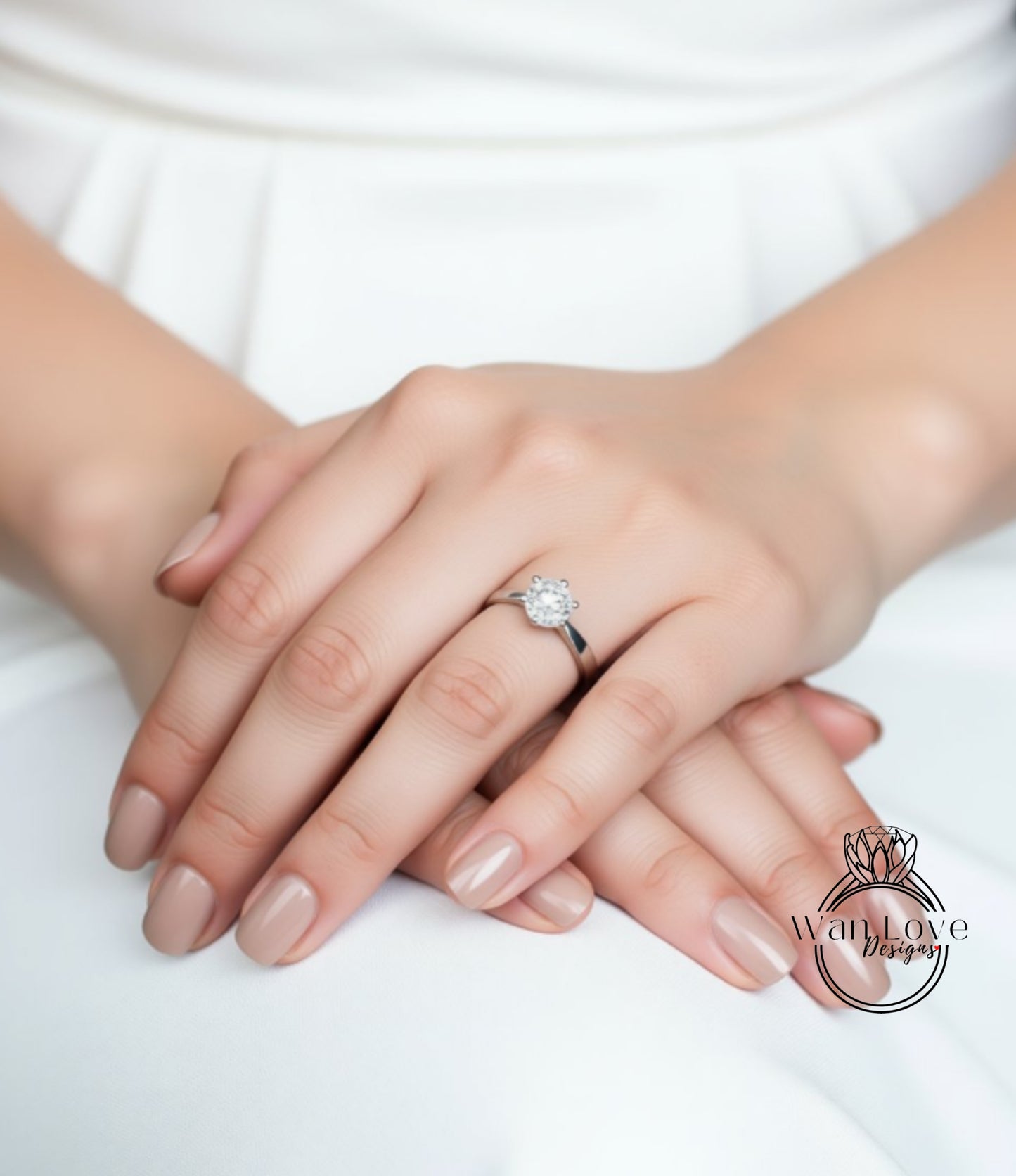 A close-up of a person's hands wearing a diamond engagement ring.