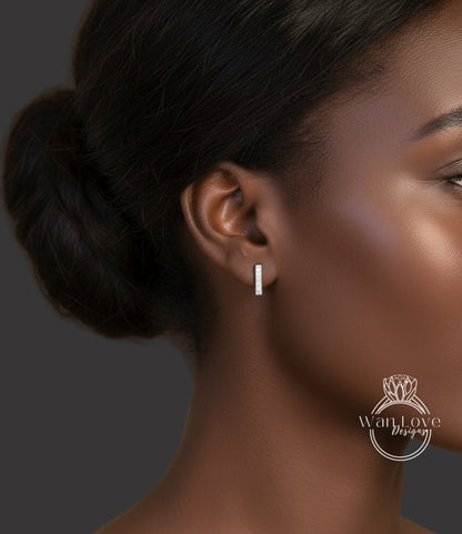 A close-up of a woman's face, focusing on her earrings and hair.