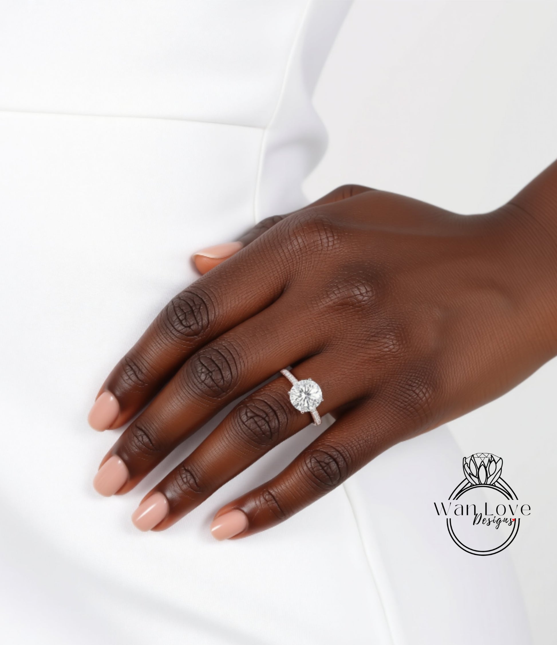A close-up of a hand wearing a diamond engagement ring.
