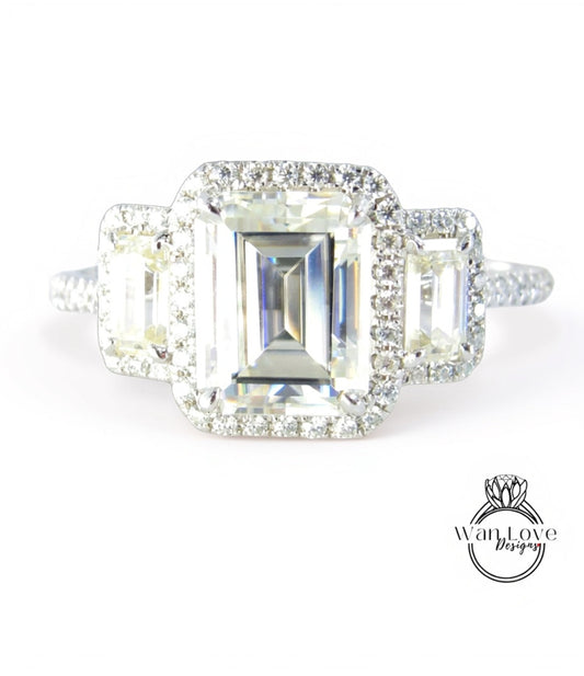 A close-up view of a diamond engagement ring with a large, clear gemstone set in a halo of smaller diamonds.