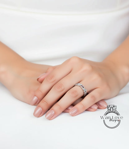 A close-up image of a person's hands wearing a ring on the ring finger.