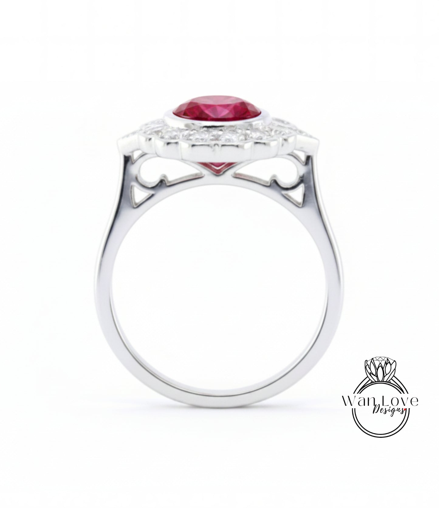 A silver ring with a large red gemstone, likely a ruby, set in a halo of smaller diamonds.