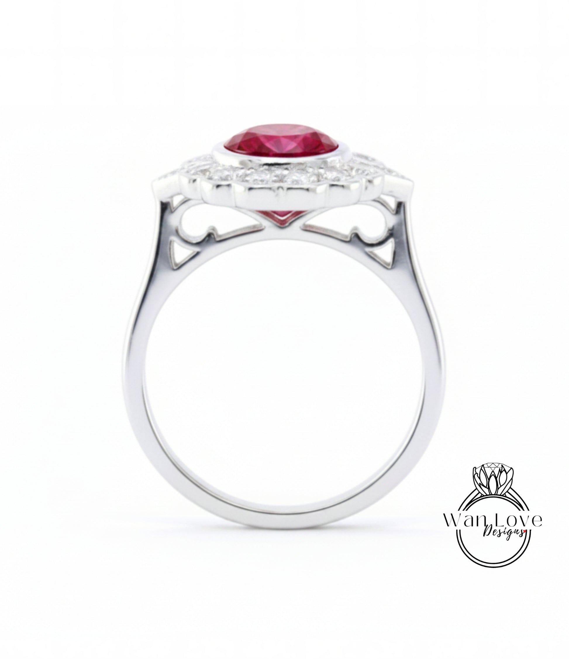 A silver ring with a large red gemstone, likely a ruby, set in a halo of smaller diamonds.
