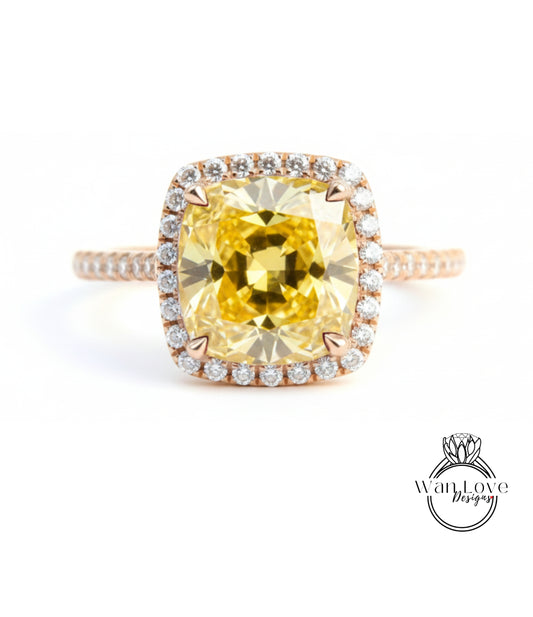 A large yellow diamond ring with a halo of smaller diamonds around the center stone.