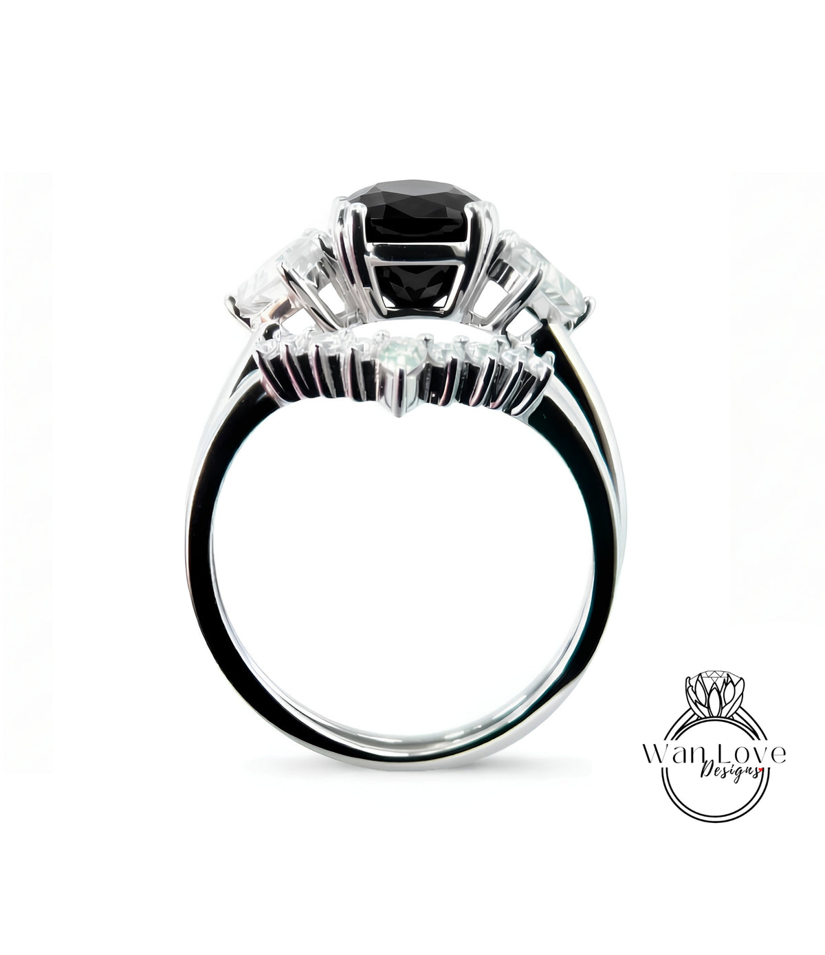 A silver ring with a large black gemstone, possibly a diamond, surrounded by smaller gemstones.