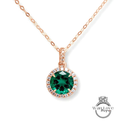 A necklace with a large, green gemstone pendant surrounded by smaller diamonds.
