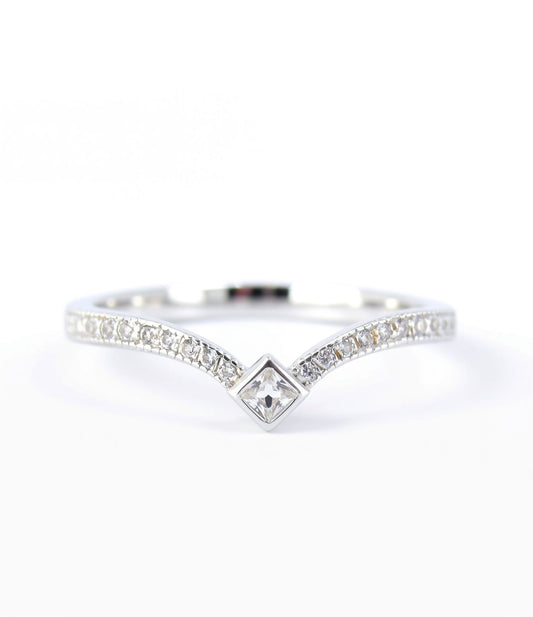A silver ring with a diamond-encrusted band and a central square-shaped diamond.