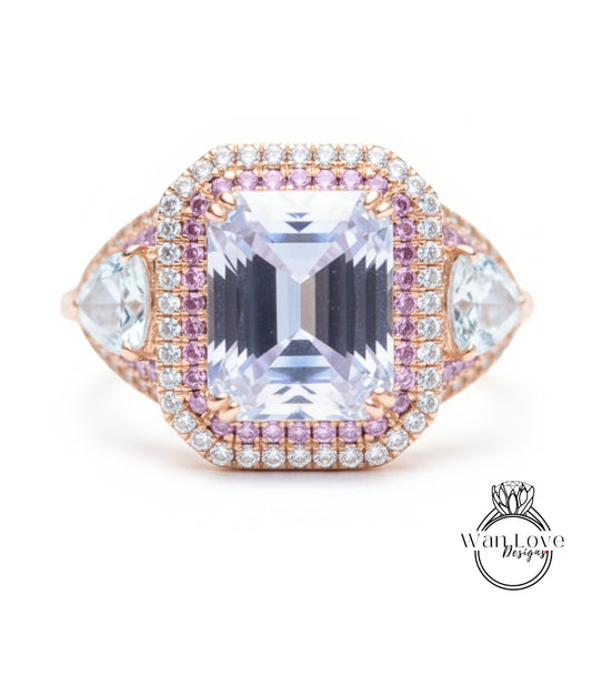 A large, ornate ring featuring a large central gemstone surrounded by smaller gemstones and diamonds in a pink and white color scheme.