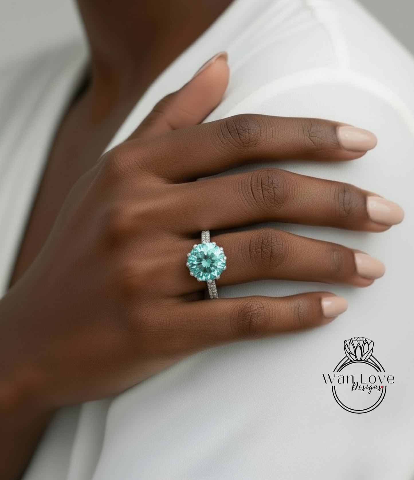 A close-up of a person's hand wearing a large, turquoise-colored diamond ring.