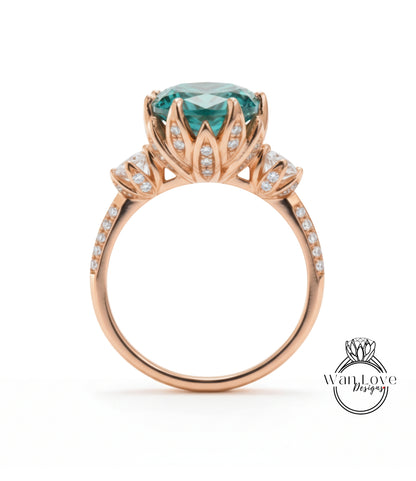 A gold ring with a large blue gemstone, likely a sapphire, surrounded by smaller diamonds and a delicate flower-like design.