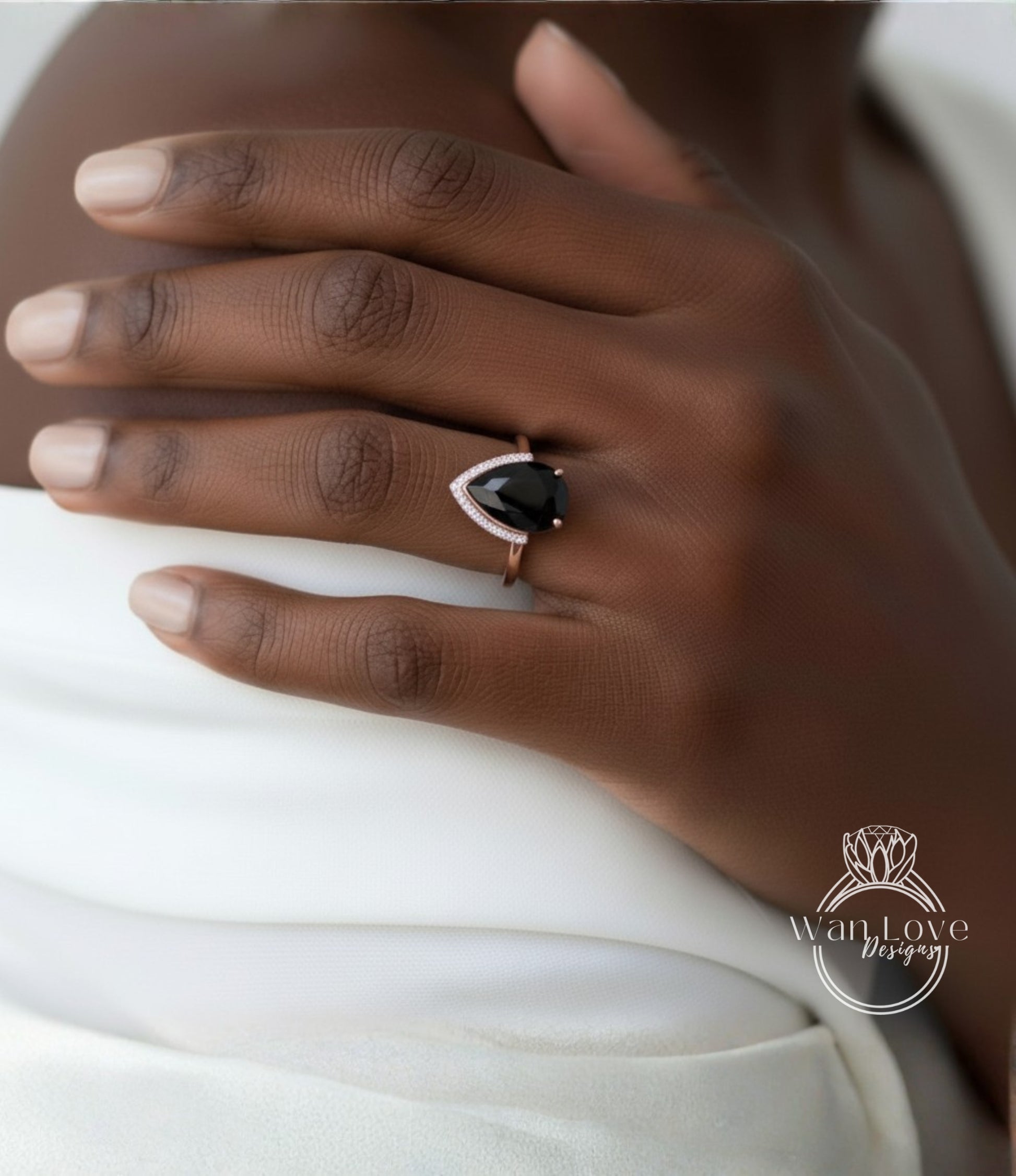 A close-up of a person's hand wearing a ring with a large black gemstone.