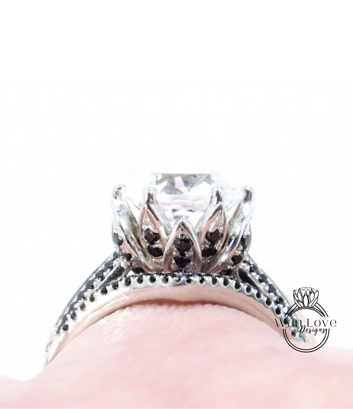 A close-up view of a diamond engagement ring with a large central diamond surrounded by smaller diamonds and a floral-inspired design.