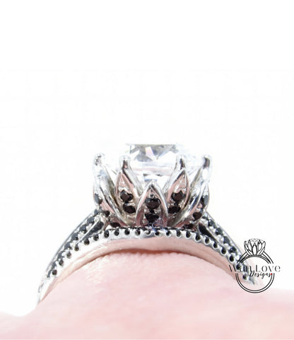 A close-up view of a diamond engagement ring with a large central diamond surrounded by smaller diamonds and a floral-inspired design.