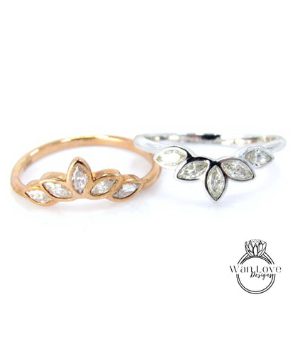 Two rings with different designs, one with a floral pattern and the other with a leaf-like pattern, both featuring small diamonds.