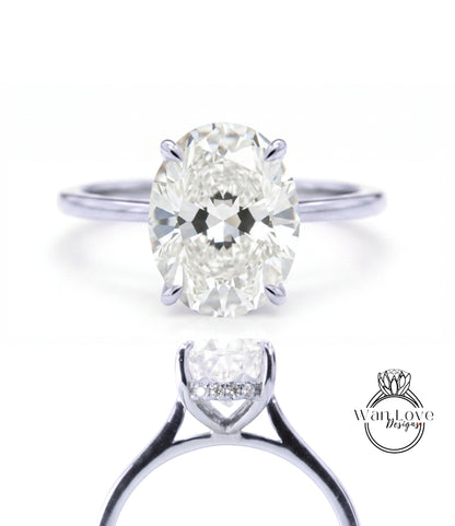A close-up of a diamond engagement ring with a large oval-shaped diamond set in a silver band.