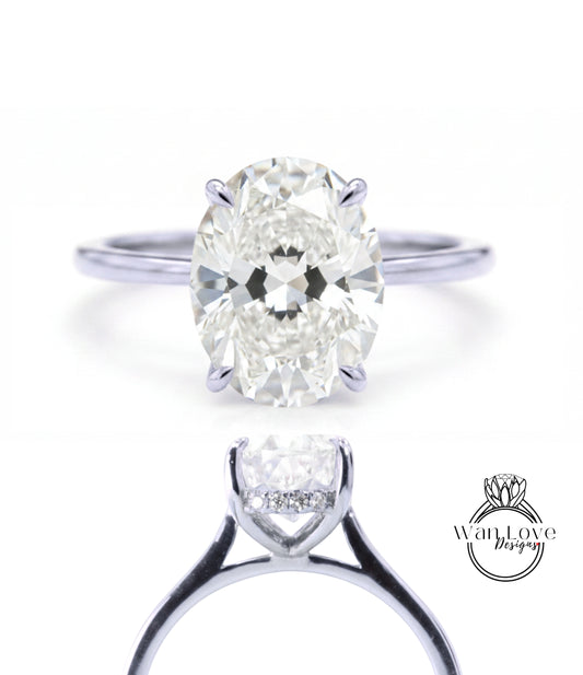 A close-up of a diamond engagement ring with a large oval-shaped diamond set in a silver band.
