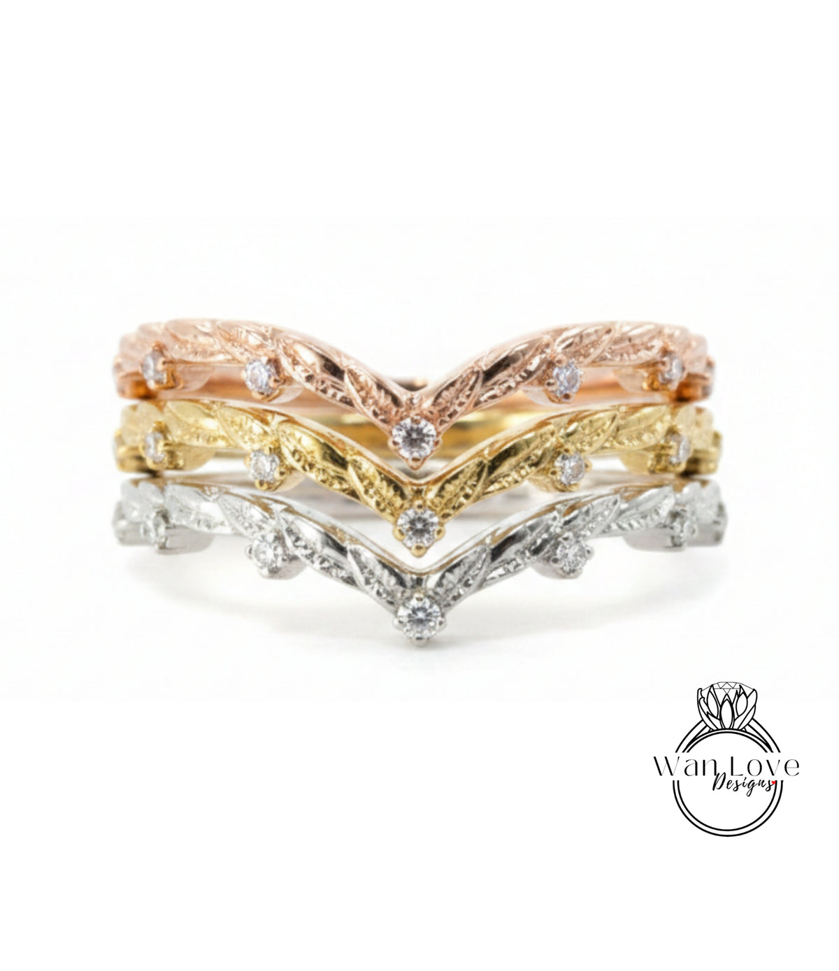A ring with three layers of rings, each with a diamond set in the center. The topmost ring is gold, the middle ring is silver, and the bottom ring is gold. The rings have a floral design.