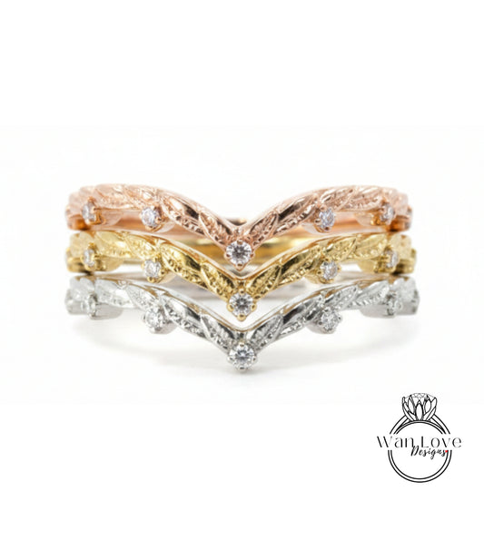 A ring with three layers of rings, each with a diamond set in the center. The topmost ring is gold, the middle ring is silver, and the bottom ring is gold. The rings have a floral design.