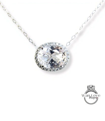 A necklace with a large, round, clear gemstone at the center, surrounded by a halo of smaller diamonds.