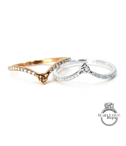 Two rings with diamonds on them are placed side by side against a white background.