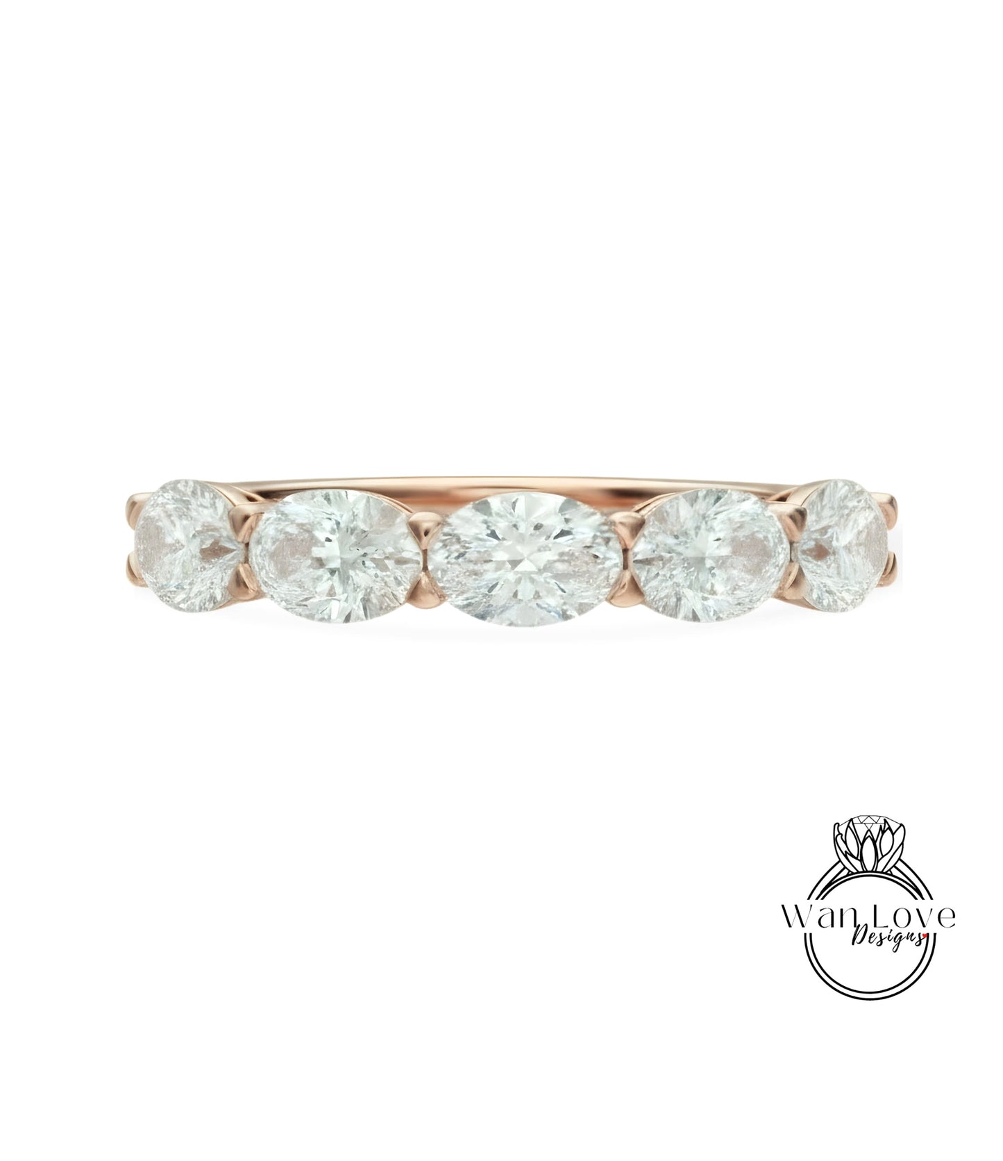 a beautiful rose gold ring with a row of five oval-shaped diamonds set in the band.