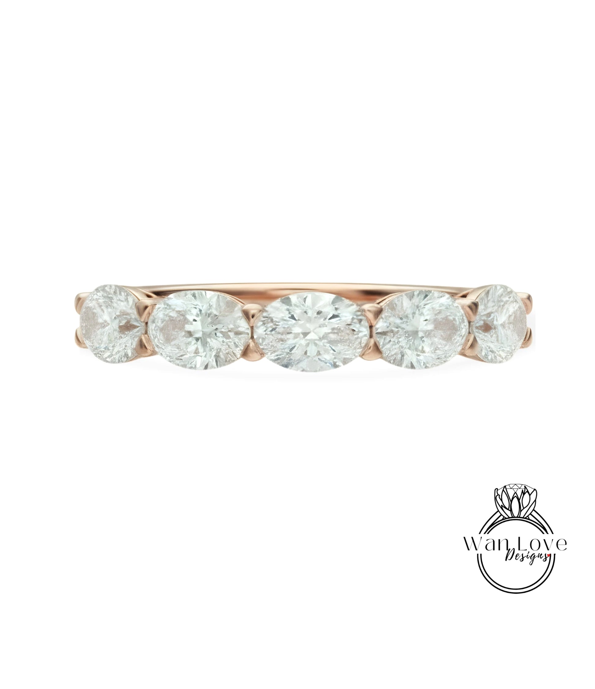 a beautiful rose gold ring with a row of five oval-shaped diamonds set in the band.