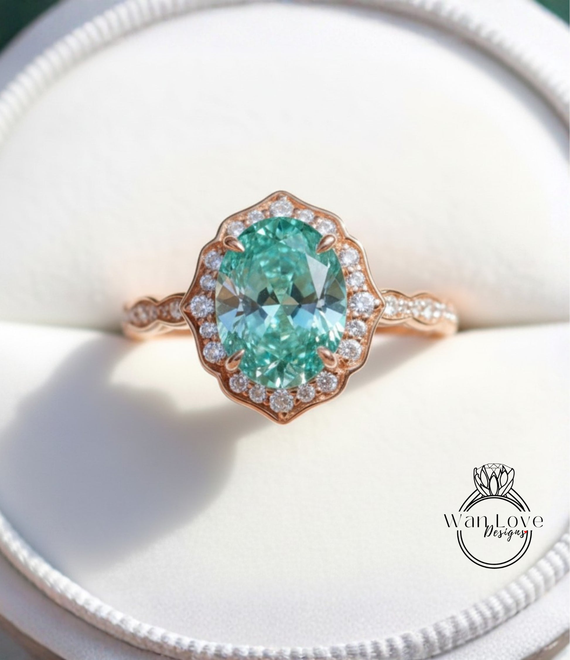 A close-up image of a beautiful engagement ring with a large oval-shaped gemstone surrounded by a halo of smaller diamonds set in a rose gold band.