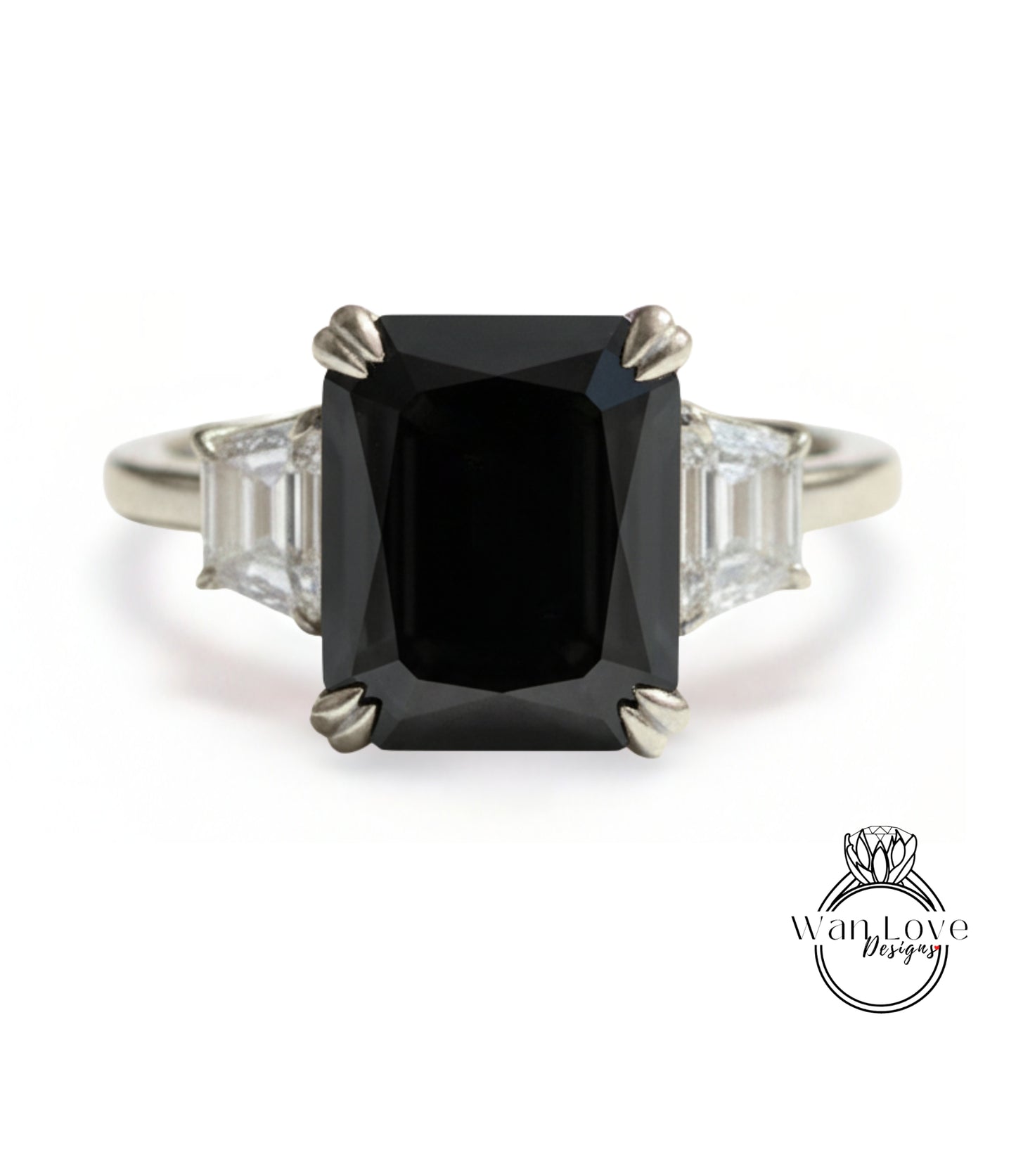 A silver ring with a large black diamond as the centerpiece, surrounded by smaller diamonds.