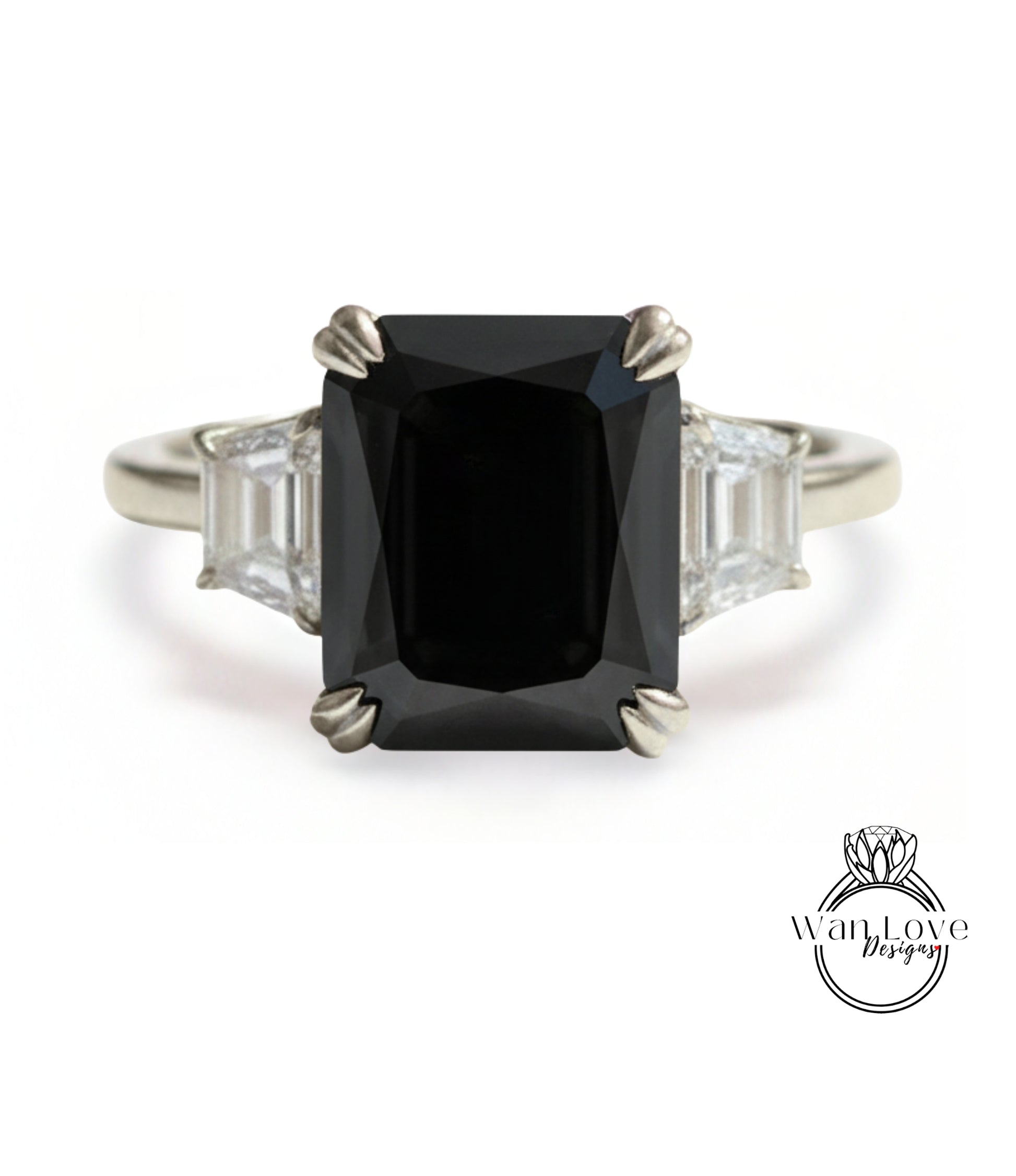 A silver ring with a large black diamond as the centerpiece, surrounded by smaller diamonds.