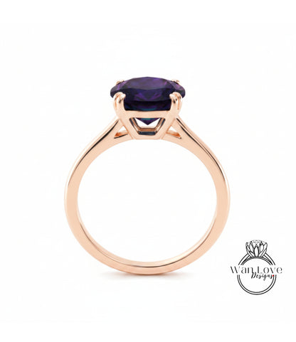 A gold ring with a large purple gemstone set in the center.