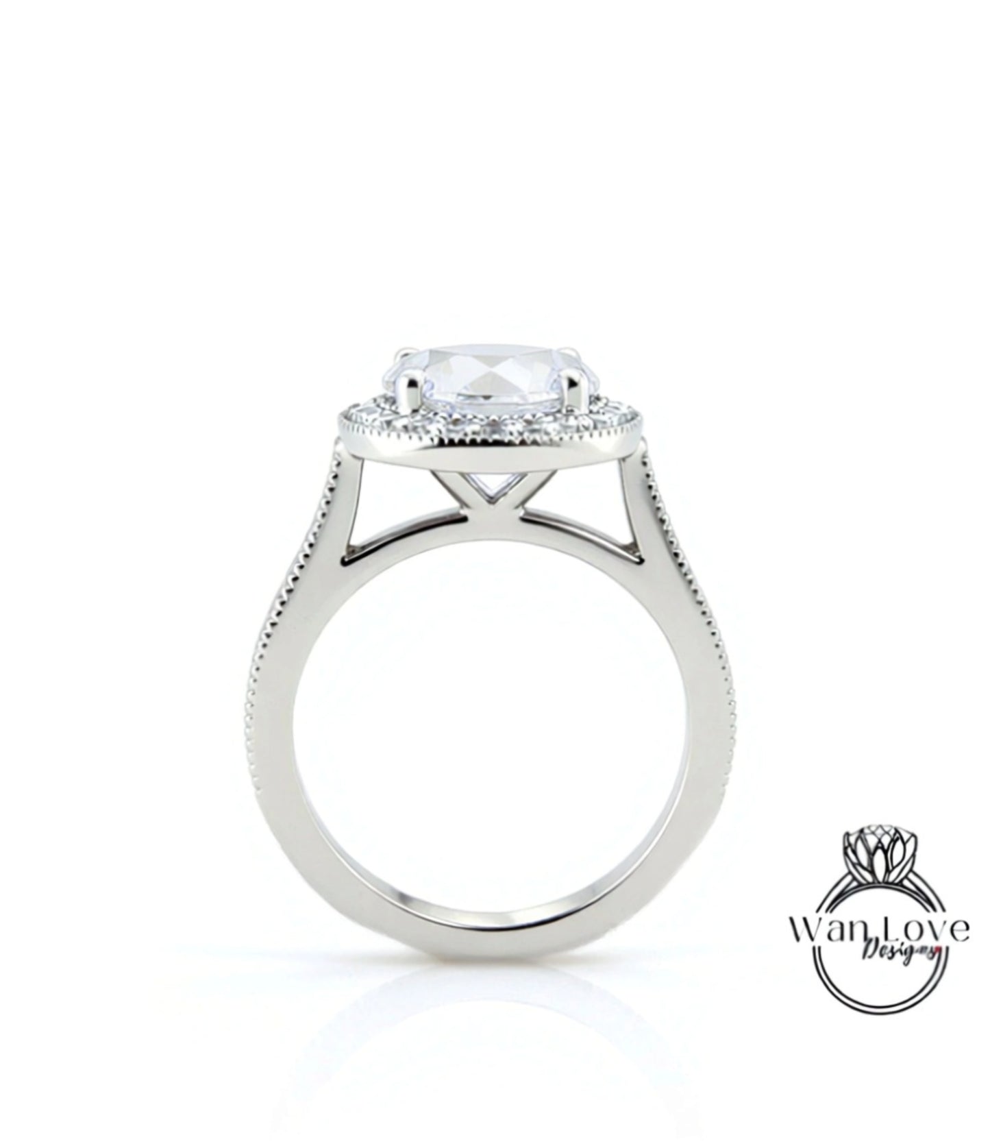 A silver engagement ring with a large central diamond and a halo of smaller diamonds around it.