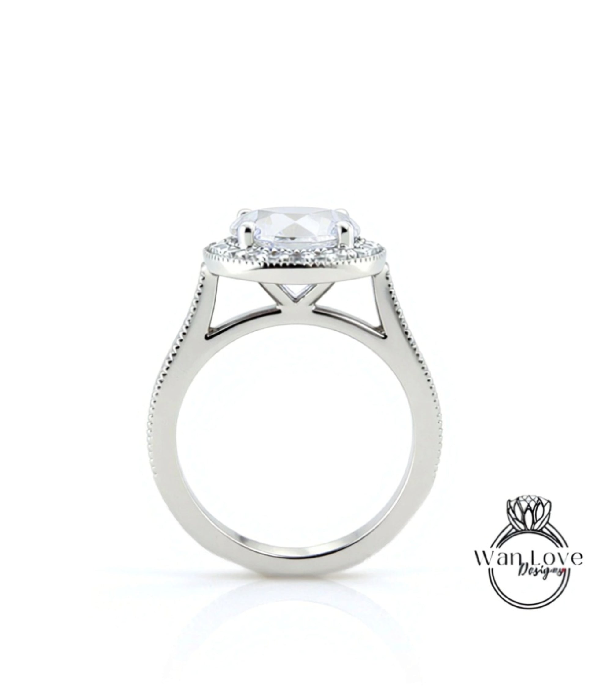 A silver engagement ring with a large central diamond and a halo of smaller diamonds around it.