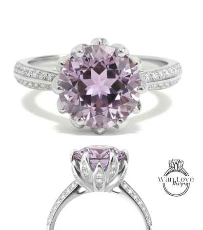 A stunning ring featuring a large, round purple gemstone set in a silver band adorned with small diamonds.