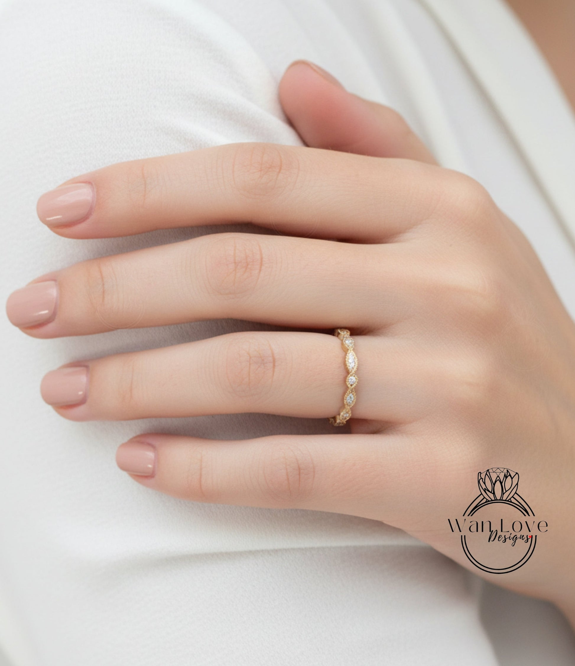A close-up of a person's hand wearing a gold ring with a diamond band.