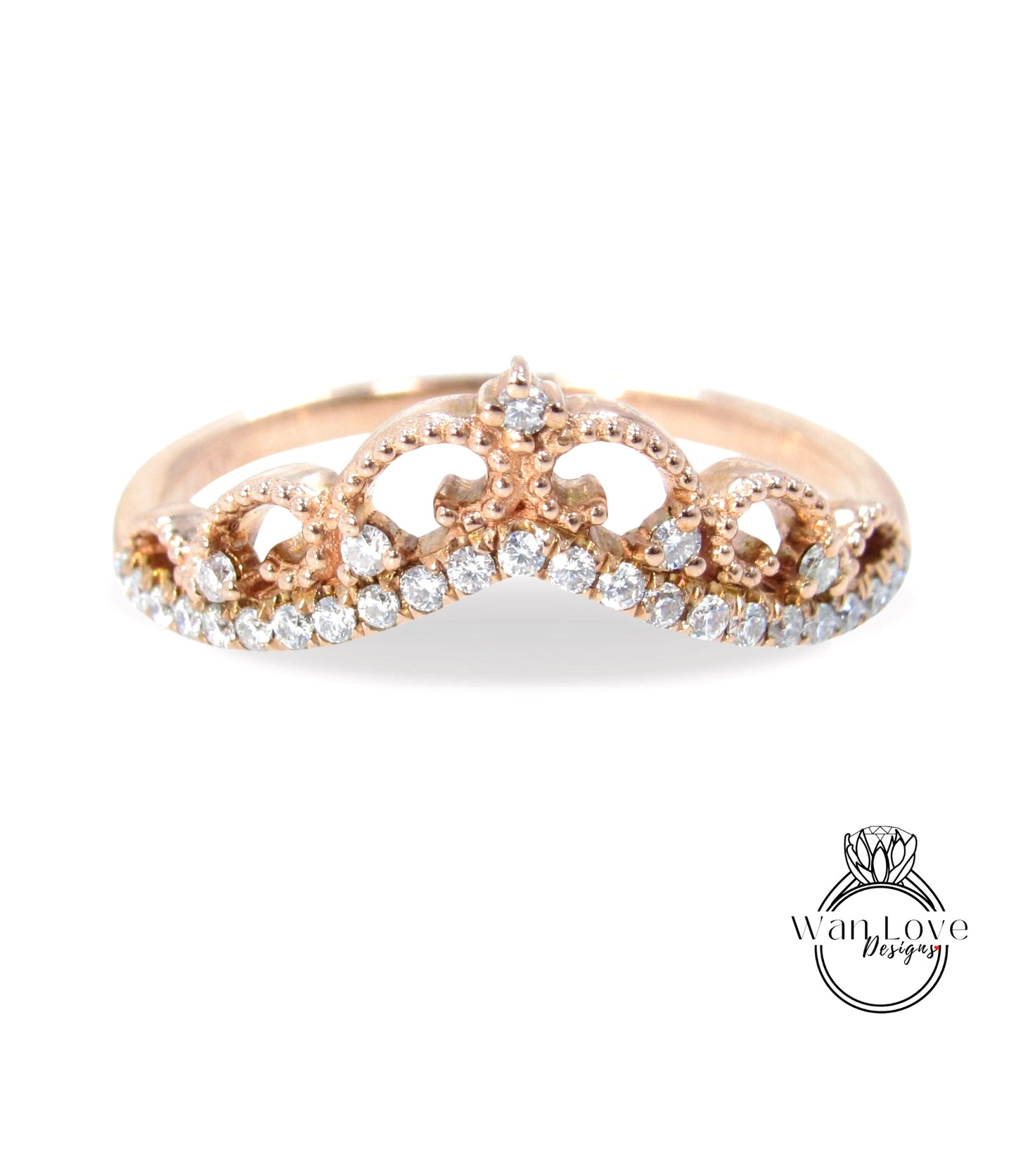 A gold-colored ring with a decorative crown-like design and small diamonds set in the center.