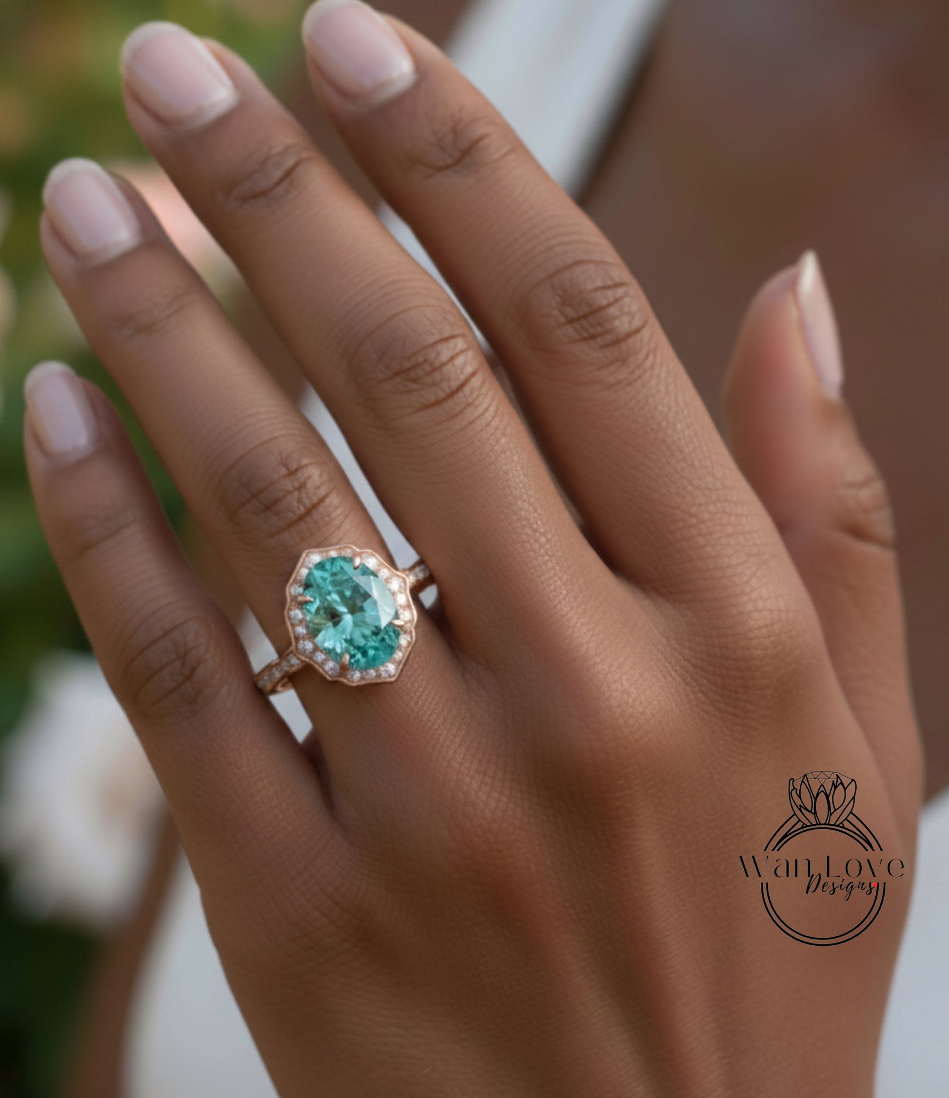 A close-up of a person's hand wearing a large, oval-shaped ring with a blue gemstone set in a gold band.