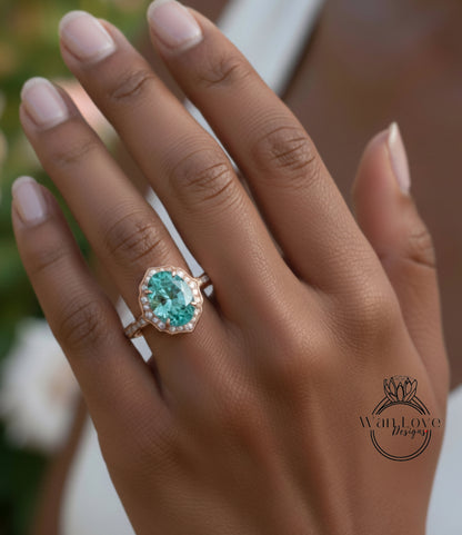 A close-up of a person's hand wearing a large, oval-shaped ring with a blue gemstone set in a gold band.