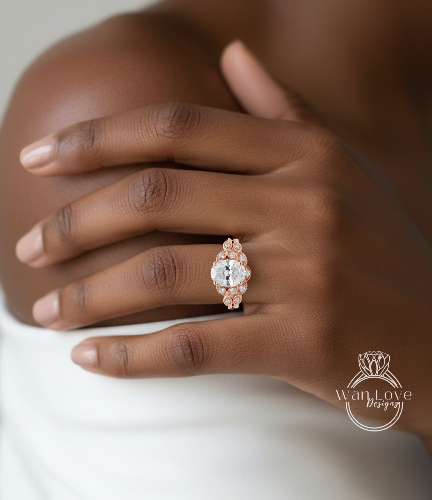 A close-up of a person's hand wearing a large, ornate diamond ring on the ring finger.