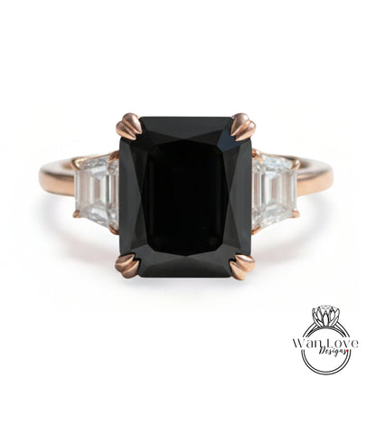 A gold ring with a large black diamond as the centerpiece, surrounded by smaller diamonds.