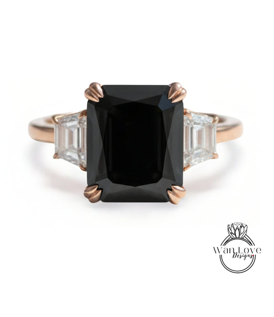 A gold ring with a large black diamond as the centerpiece, surrounded by smaller diamonds.