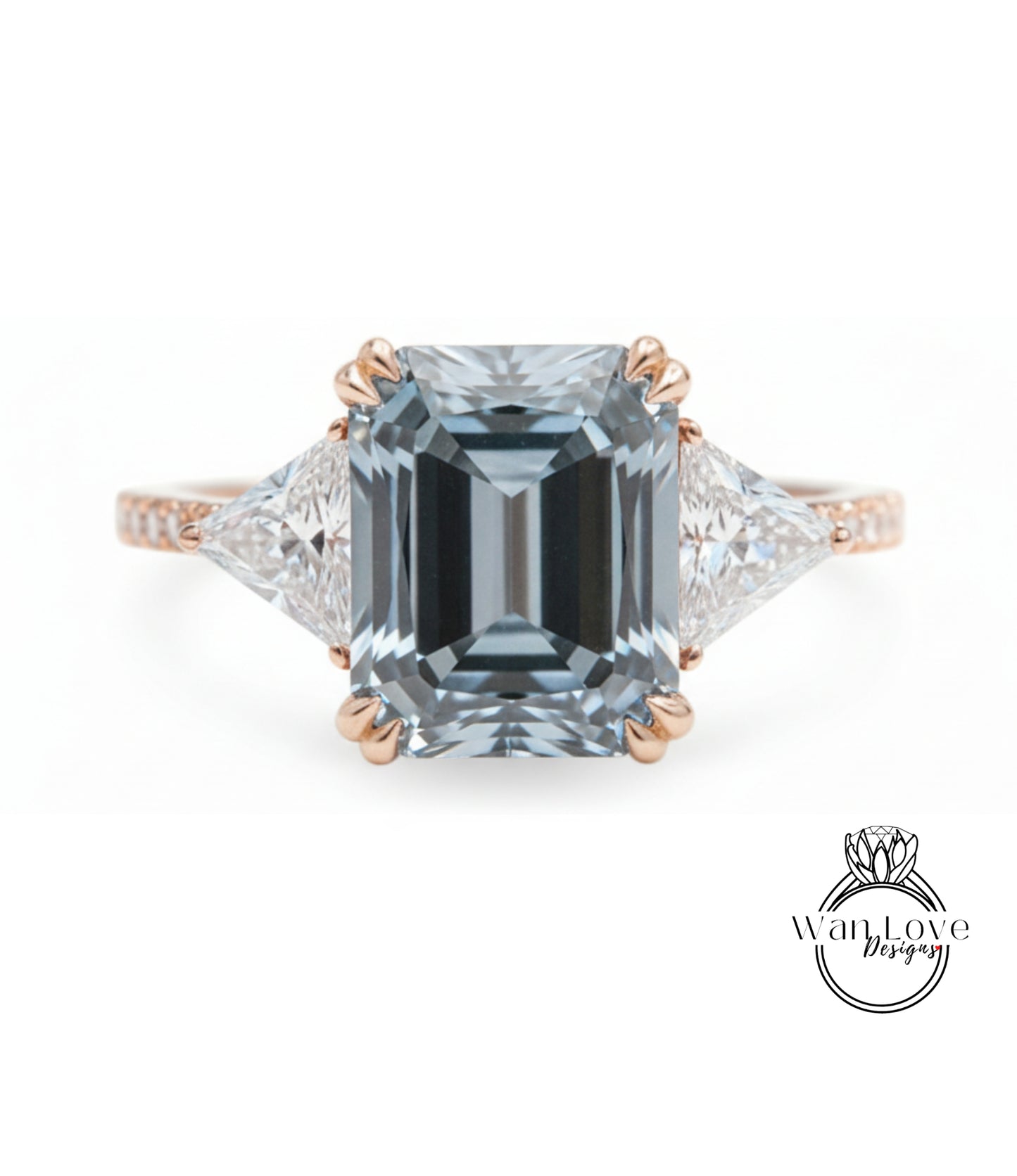 A large, blue diamond engagement ring with a gold band and three smaller diamonds on either side.