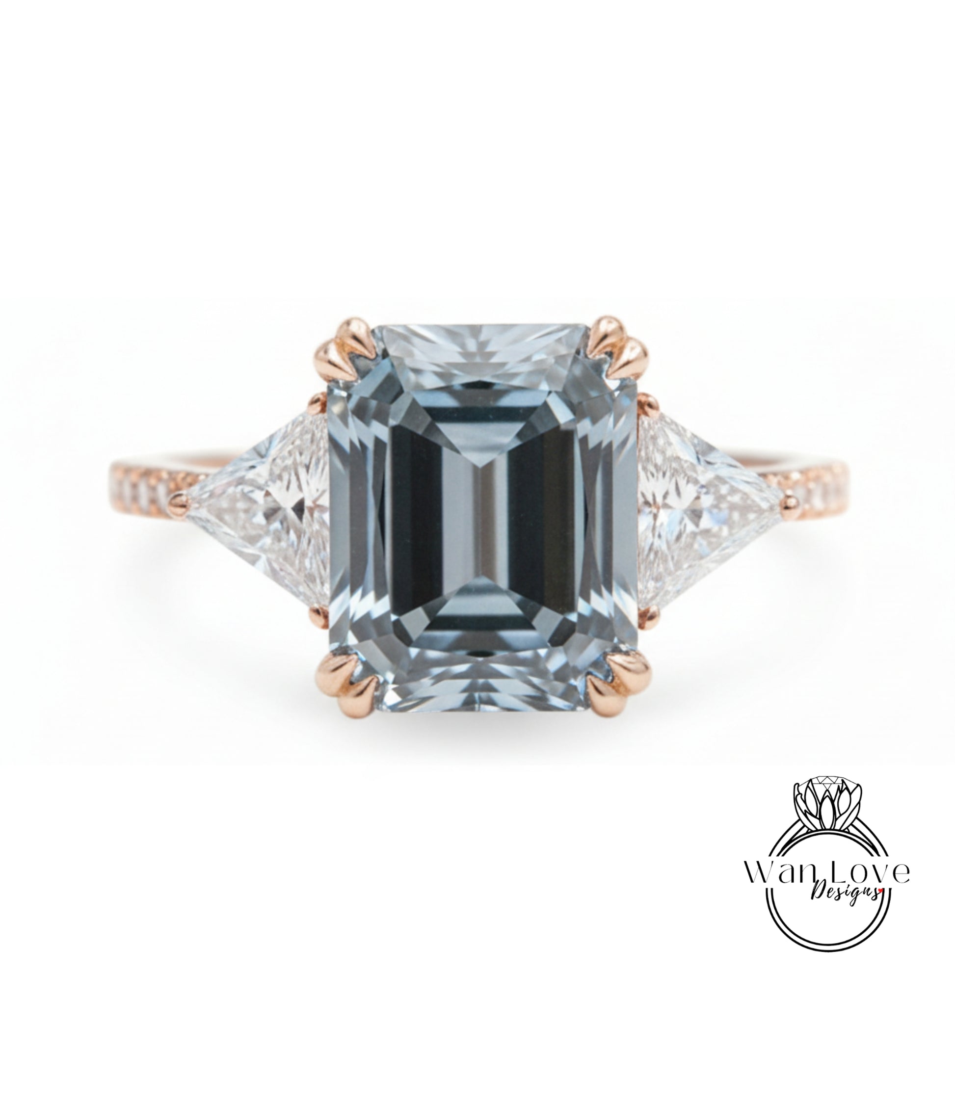 A large, blue diamond engagement ring with a gold band and three smaller diamonds on either side.