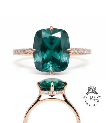 A large, green gemstone engagement ring with a gold band and small diamonds.