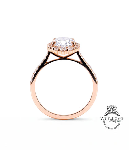 A rose gold engagement ring with a large central diamond and smaller diamonds around the halo.