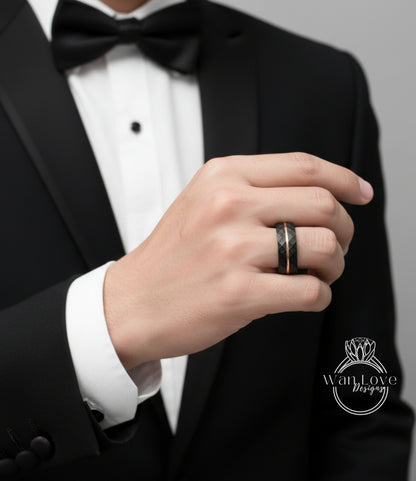A close-up of a person's hand wearing a black tuxedo and a ring on the finger.