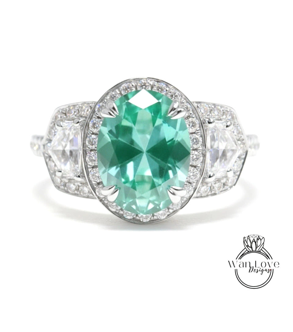 A stunning engagement ring with a large oval-shaped gemstone surrounded by smaller diamonds, set in a silver band.