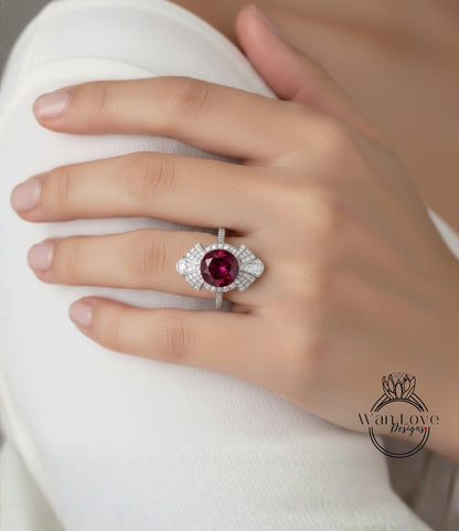 A close-up of a person's hand wearing a large, ornate ring with a large, round gemstone.