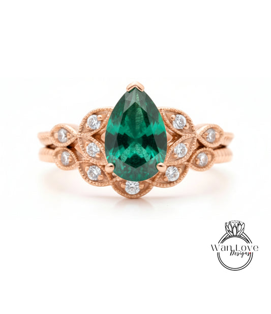 a beautiful engagement ring with a large, vibrant green gemstone set in an ornate gold band.
