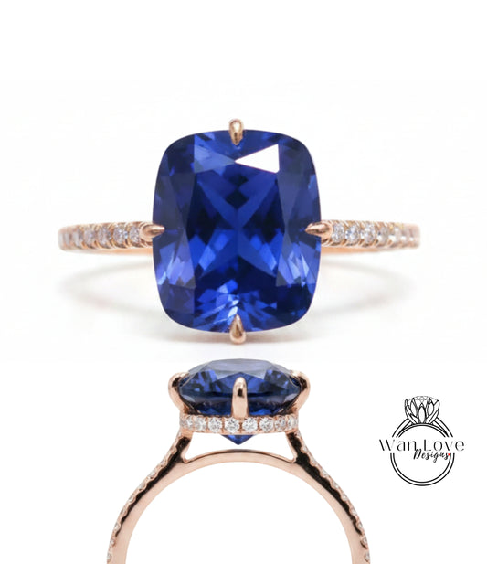 A close-up view of a gold ring with a large blue gemstone, showcasing the intricate design and craftsmanship of the piece.